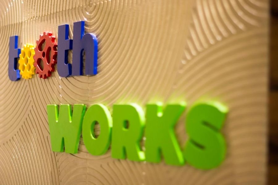 Tooth Works lettering on a textured wall
